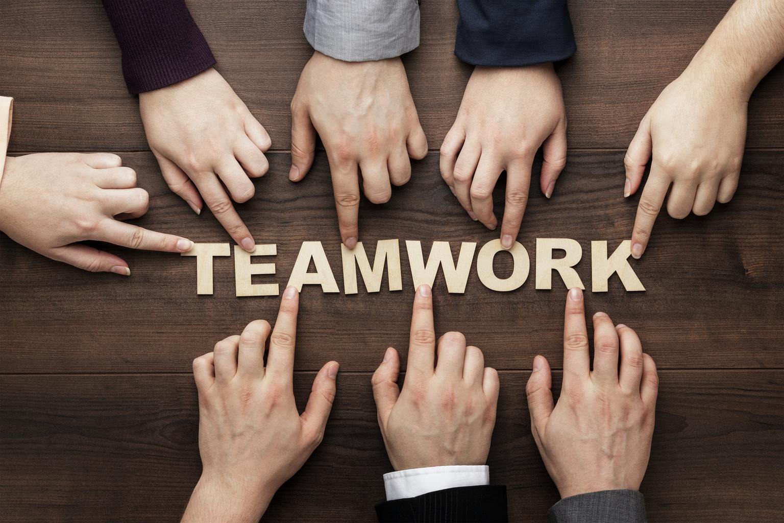 6532431a769b1188055b60c1 teamwork concept on the brown wooden table background